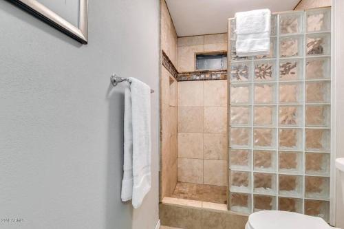 a bathroom with a shower with a toilet and towels at ULTRA COZY CASITA BY DTWN PHX in Phoenix