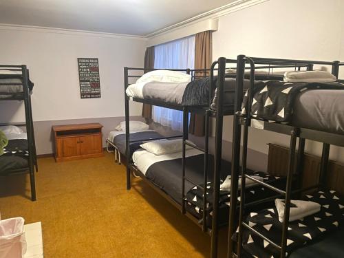 a room with bunk beds in a dorm room at The Eagle in Bluff