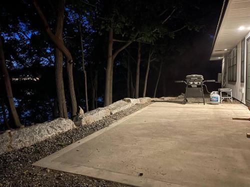 a barbecue grill sitting in front of a house at night at New ranch on RIVER with spectacular views in Brewer