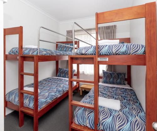 a bunk room with three bunk beds in it at BIG4 Emu Beach Holiday Park in Albany