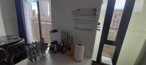 a kitchen counter with utensils on a window sill at Wohnung Queens Deluxe in Bogotá