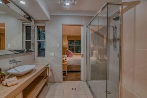 a bathroom with a shower and a sink at Narrows Escape Rainforest Retreat in Montville