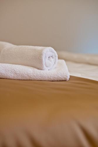 a stack of towels sitting on top of a bed at Hotel Soldo in Međugorje