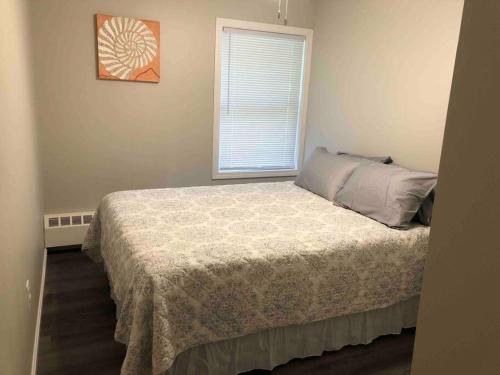 a bedroom with a bed and a window at Spacious Home near Airport in Bangor