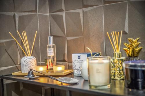 a table with candles and other items on it at L'Eden Love - Jacuzzi / Sauna in Grenoble