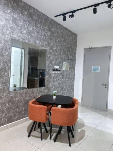 a black table and two orange chairs in a room at WiFi Deco Home at Manjalara Free WiFi and Parking - MSuite at Bandar Manjalara, Near to DesaPark, Arkadia, One Utama, Kepong, Sri Damansara, Kota Damansara, Kuala Lumpur in Kuala Lumpur
