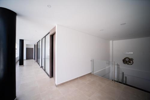 a hallway with white walls and a tile floor at Hermosa habitación para pareja in Rozo
