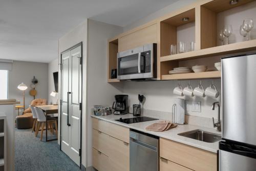 a kitchen with a sink and a microwave at TownePlace Suites by Marriott Buckeye Verrado in Buckeye
