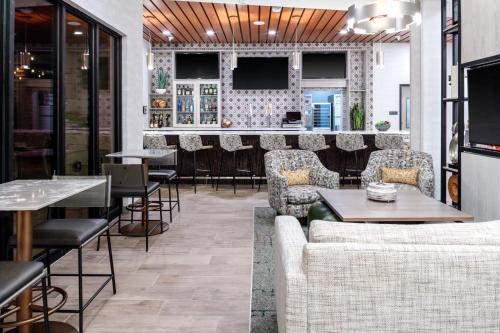 a restaurant with couches and tables and a bar at TownePlace Suites by Marriott Buckeye Verrado in Buckeye