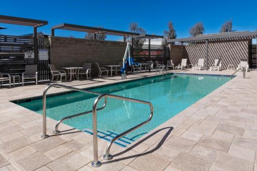 a swimming pool with a metal hand rail in a building at TownePlace Suites by Marriott Buckeye Verrado in Buckeye