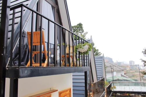 a balcony of a house with chairs on it at CuDen Homestay Venuestay in Vĩnh Phúc