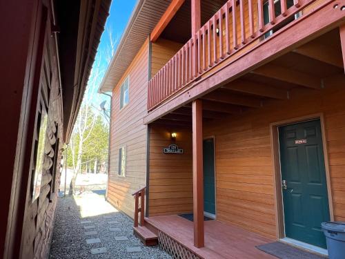 a porch of a house with a green door at Faithful Street Inn in West Yellowstone