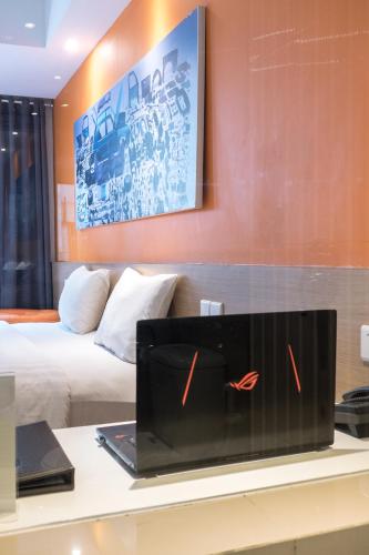 a laptop on a desk in a hotel room at The Hills Batam in Nagoya