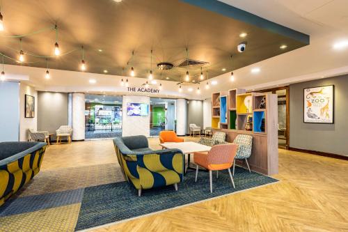 a lobby of a store with chairs and a table at Holiday Inn London - Regent's Park by IHG in London