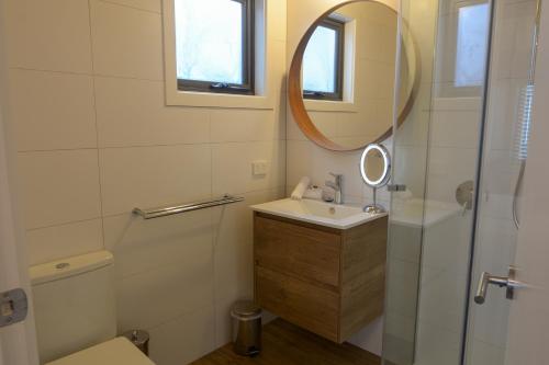 a bathroom with a sink and a mirror at Discobolus 2 in Mount Buller