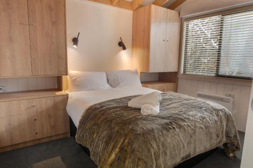 a bedroom with a large bed in a room at Discobolus 2 in Mount Buller