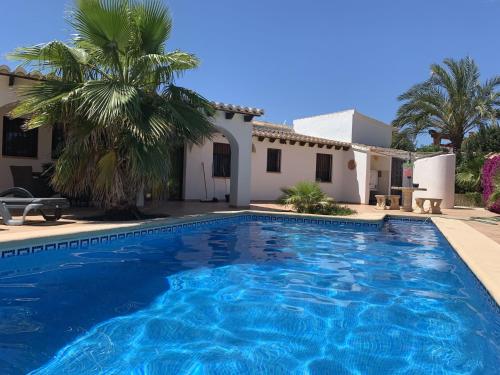 a swimming pool in front of a house at Nice villa in Moraira with private pool and lots of privacy in Moraira