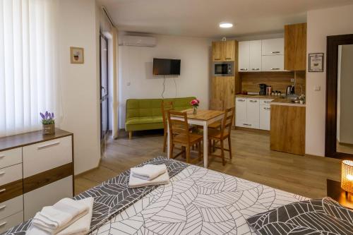 a living room with a kitchen and a dining room at D'arte Studio in Balchik
