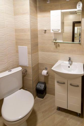 a bathroom with a toilet and a sink at D'arte Studio in Balchik