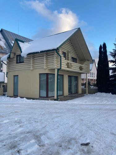 a house with snow on the ground at Golden Lemon in Mizhhirʼʼya
