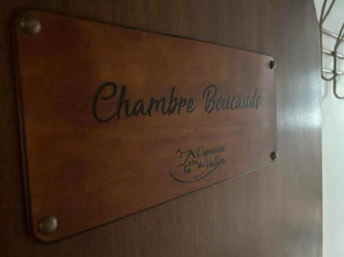a sign on a wall with the name of a restaurant at Demeure du Vallon - Chambres d'Hôtes de Charme in Azerat