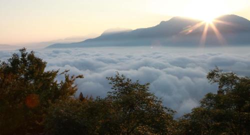 a view of the sun rising over a sea of clouds at Three Maybe B&B in Lugu