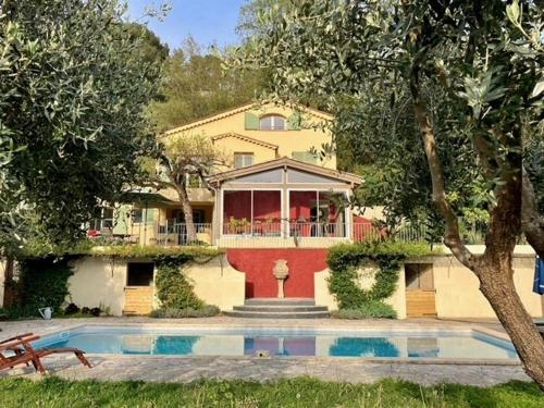 a house with a swimming pool in front of it at Villa Belle Vue in Saint Paul de Vence