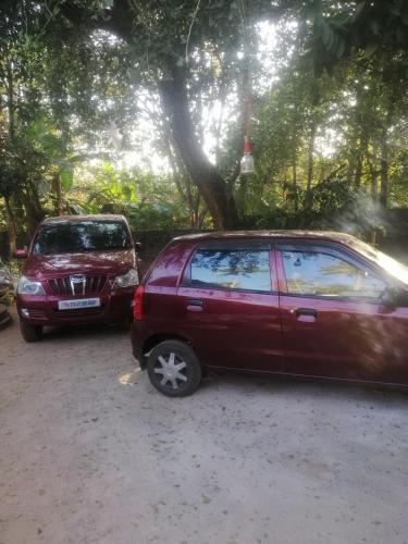 two cars parked next to each other in a parking lot at CLIFF HEAVEN in Varkala