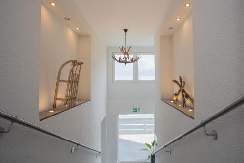 a hallway with a staircase with a chandelier at Winterbergerstrasse 3, Winterberg-Neuastenberg 'Wintertraum' in Winterberg