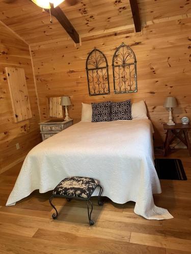 a bedroom with a bed in a log cabin at Pet Friendly, Peaceful Cabin Near Wineries, in Tryon