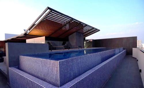 a swimming pool on the roof of a building at Apartamento - Sky Tower 1005 in Lima