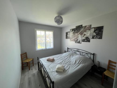 1 dormitorio con 1 cama con 2 sillas y una ventana en Maison "Gure Zerua", Pays Basque, en Cambo-les-Bains