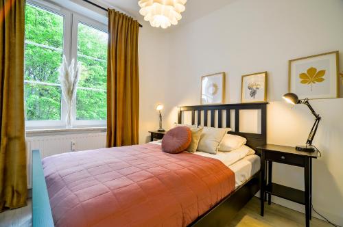 a bedroom with a bed and a large window at CITYSTAY Old Town Gdansk Apartment in Gdańsk