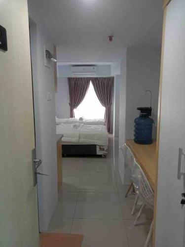 a room with a bedroom with a bed and a window at Studio unit Deprima Apartemen in Medan