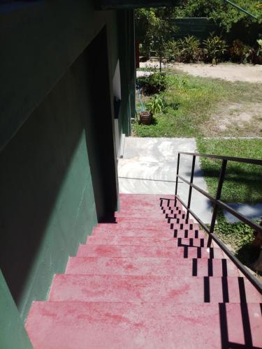 a pink carpeted staircase leading to a building at Inn On The Bay Home in Kalkudah