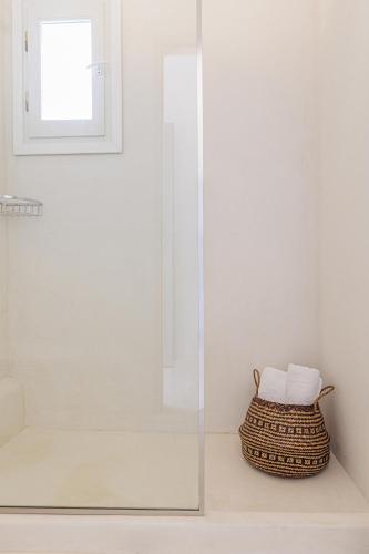 a bathroom with a shower with a glass door at Irida Vacation suites in Kastraki Naxou