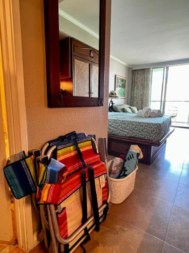a room with a pile of luggage and a bed at Luana Waikiki Park Views in Honolulu