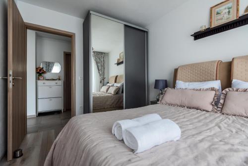 a bedroom with a large bed with a large mirror at Lovely chic studio, on a beautiful promenade in Braşov