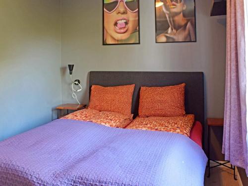 a bedroom with a bed with a purple comforter at Apartment Frederikstad II in Fredrikstad