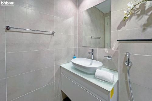 a bathroom with a sink and a mirror at bnbmehomes - Damac Hills Studio w City View - 2504 in Dubai