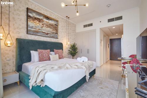 a bedroom with a large bed in a room at bnbmehomes - Damac Hills Studio w City View - 2504 in Dubai