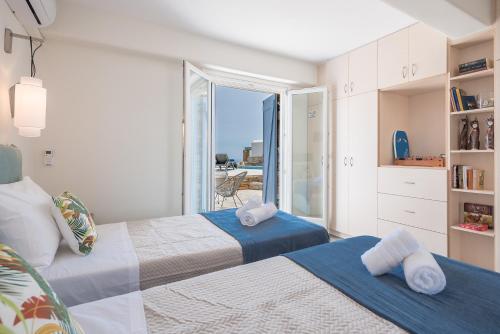 a bedroom with two beds with a view of the ocean at Flaias Gi Villa Retreat in Agia Mavra