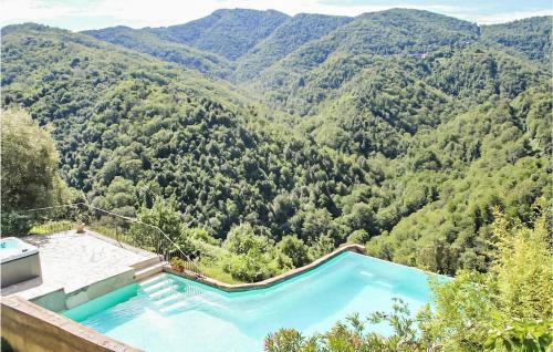 a swimming pool with a view of a mountain at Gorgeous Apartment In Carcheto Brustico in Carcheto