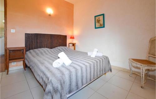 a bedroom with a bed with two white towels on it at 1 Bedroom Nice Apartment In Carcheto Brustico in Carcheto
