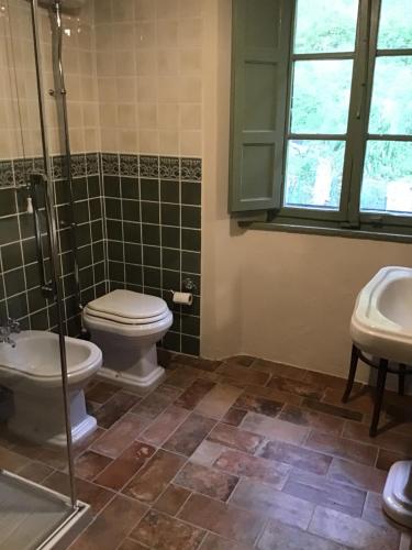 uma casa de banho com um WC, um chuveiro e um lavatório. em Canapali em Longoio