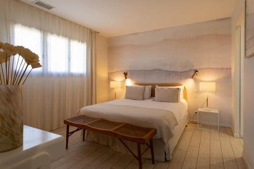a bedroom with a large bed and a window at Villas les Capucines in Sète