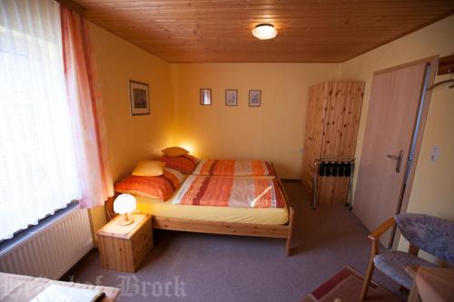 a bedroom with a bed and a table and a window at Gästehaus Heidehof in Soltau