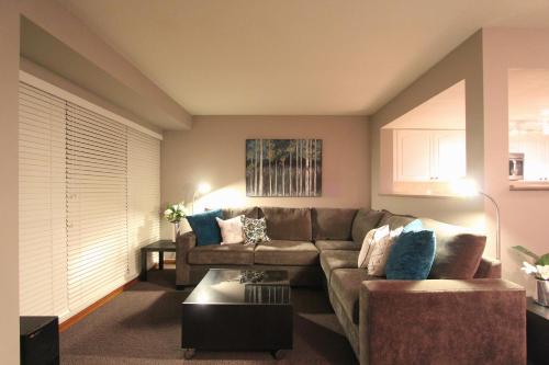 a living room with a couch and a table at Sunpath Condos by Whistler Retreats in Whistler