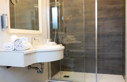 a bathroom with a sink and a shower at Hotel Aurora in Lido di Jesolo