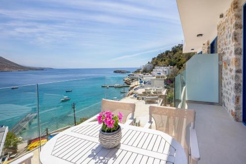 a balcony with a table with a view of the ocean at Molos Apartments in Loutro